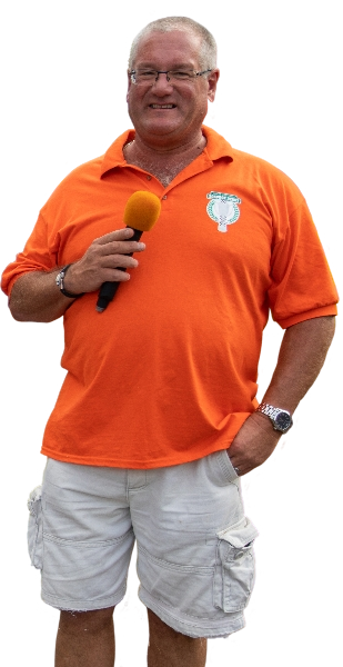 A picure of Pete Andrew, the GCSD chairman, in an orange SBD top preparing to announce race winners