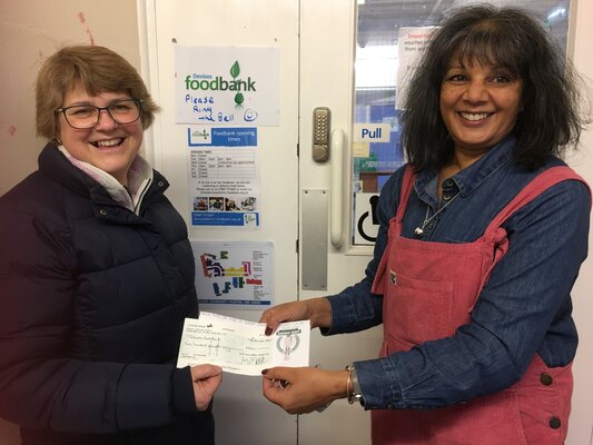 Jane Andrew from the Soap Box Derby Committee presents a cheque for £500 to Devizes foodbank