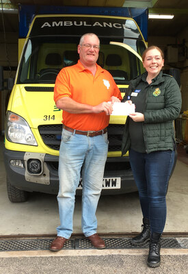Pete Andrew from the Soap Box Derby Committee presents a cheque for £4000 to the south west ambulance station